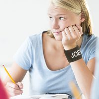 high school girl daydreaming with a black memorial custom sweatband that says Joey